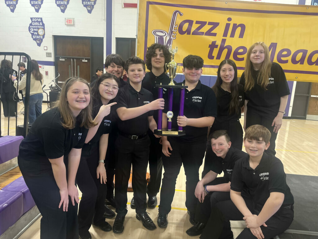 A group of students poses with a trophy that they won during the Jazz in the Meadows festival in Rolling Meadows