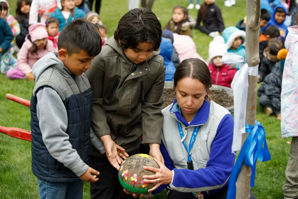 Second graders at Field help deliver two painted stones to the grounds of the new tree