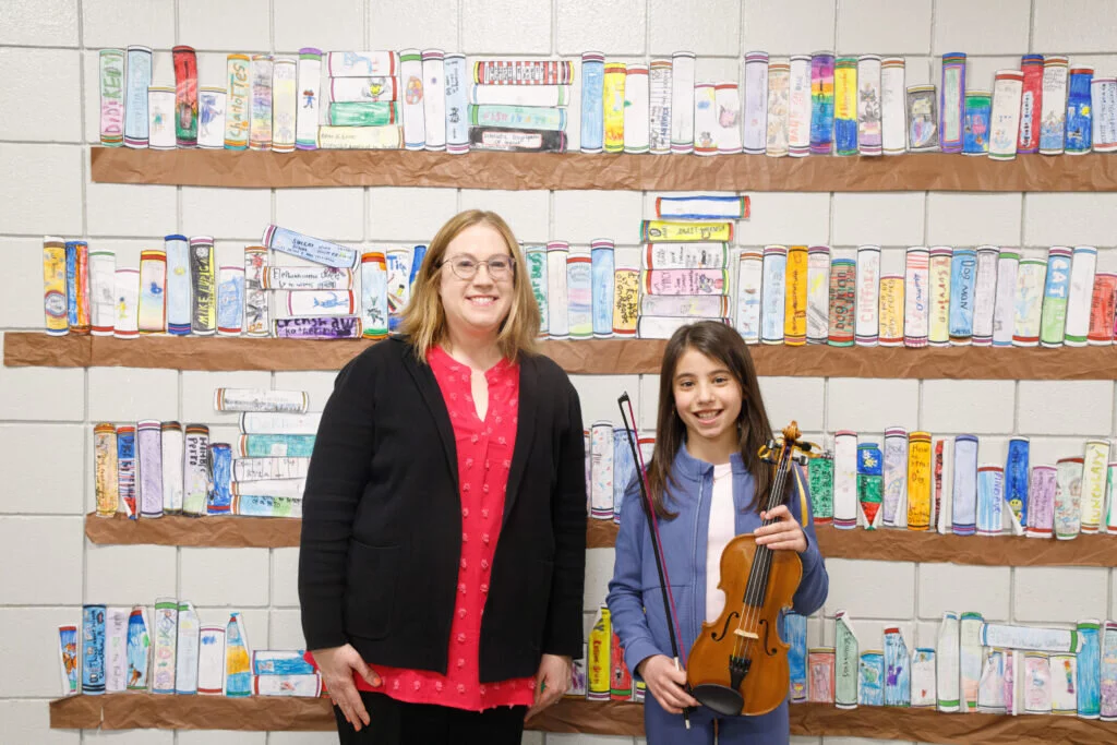 Julia stands with Lauren Wargaski, orchestra director for the London strand of schools