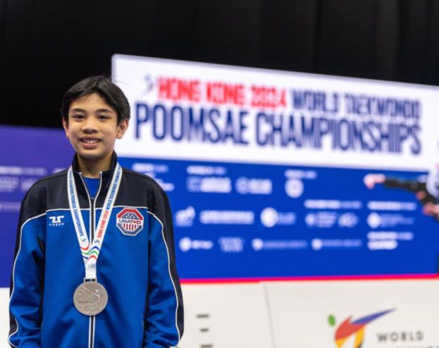 Photo of Aiden with silver medal. 