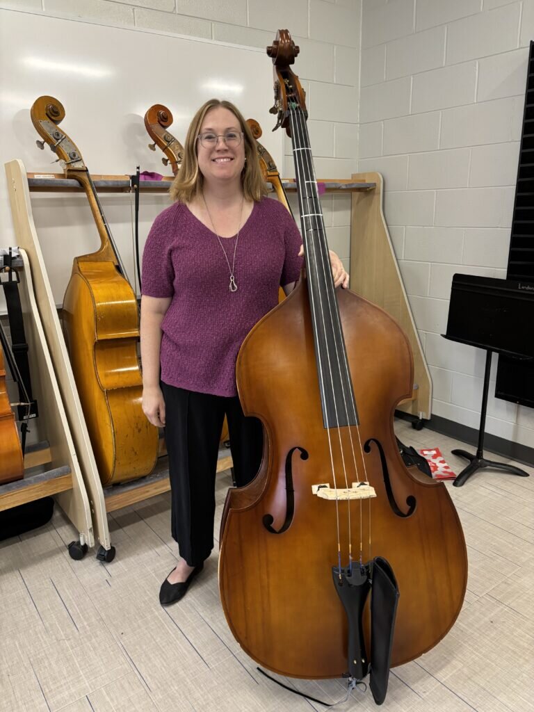 Picture of instrumental music teacher Lauren Wargaski with a chello