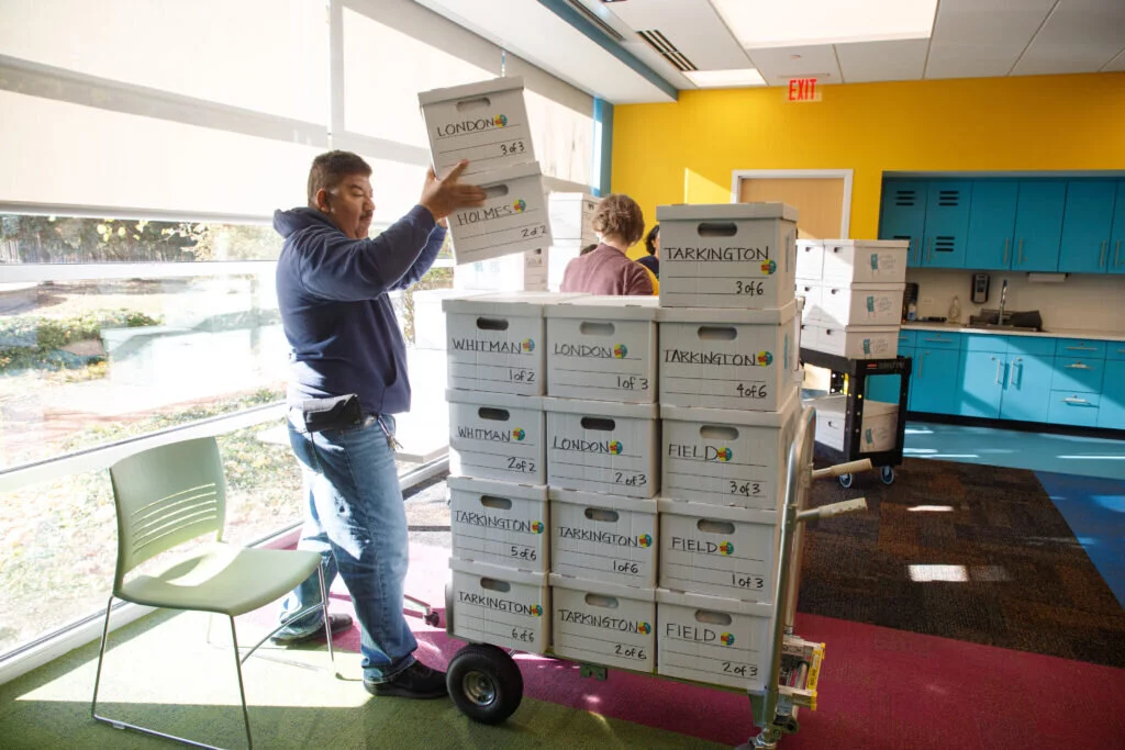 Staff at Indian Trails load up the boxes on carts to move them to a district-supplied truck.
