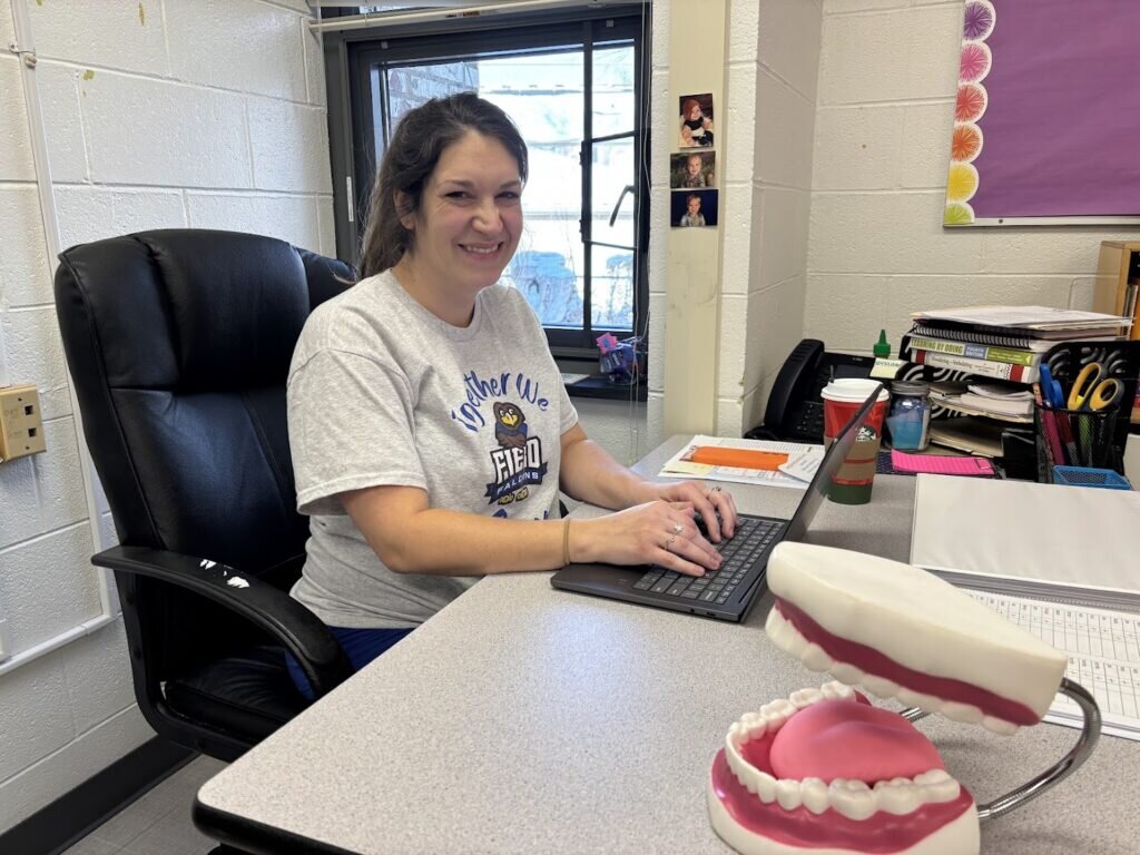 Natalie typing at her desk. 