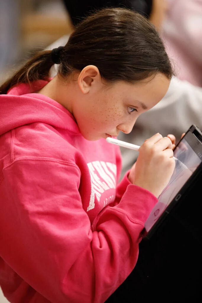A Twain student sketches away on her iPad.