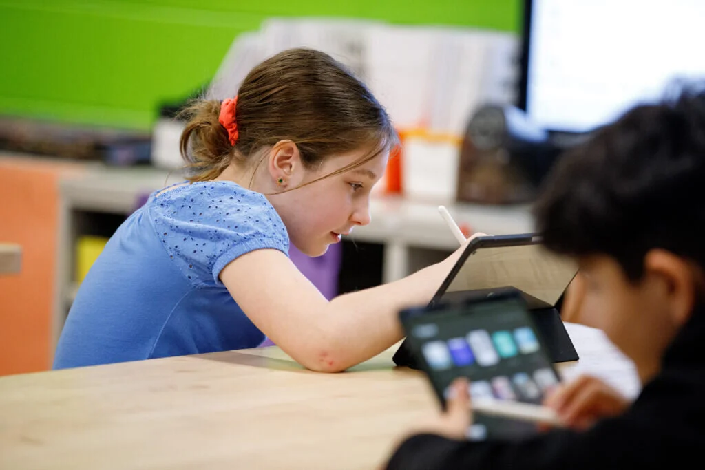 A Riley student sketches away during art class.