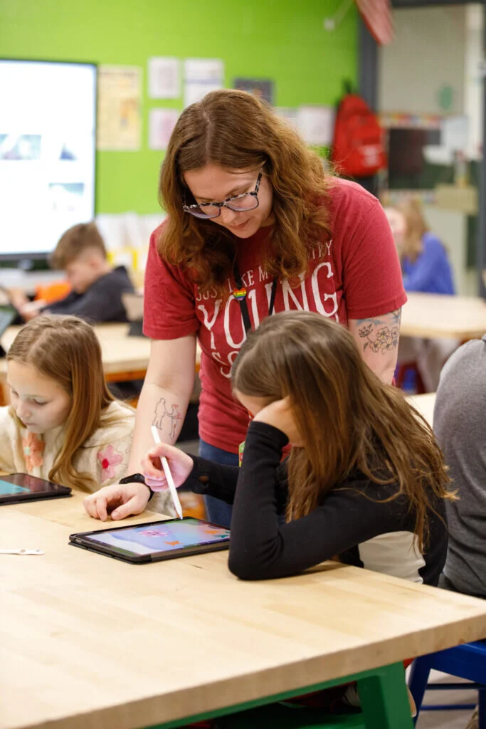 Julia Mikos, art teacher at Riley, helps answer a technical question about Procreate, the art software used by the district as part of the pilot project.